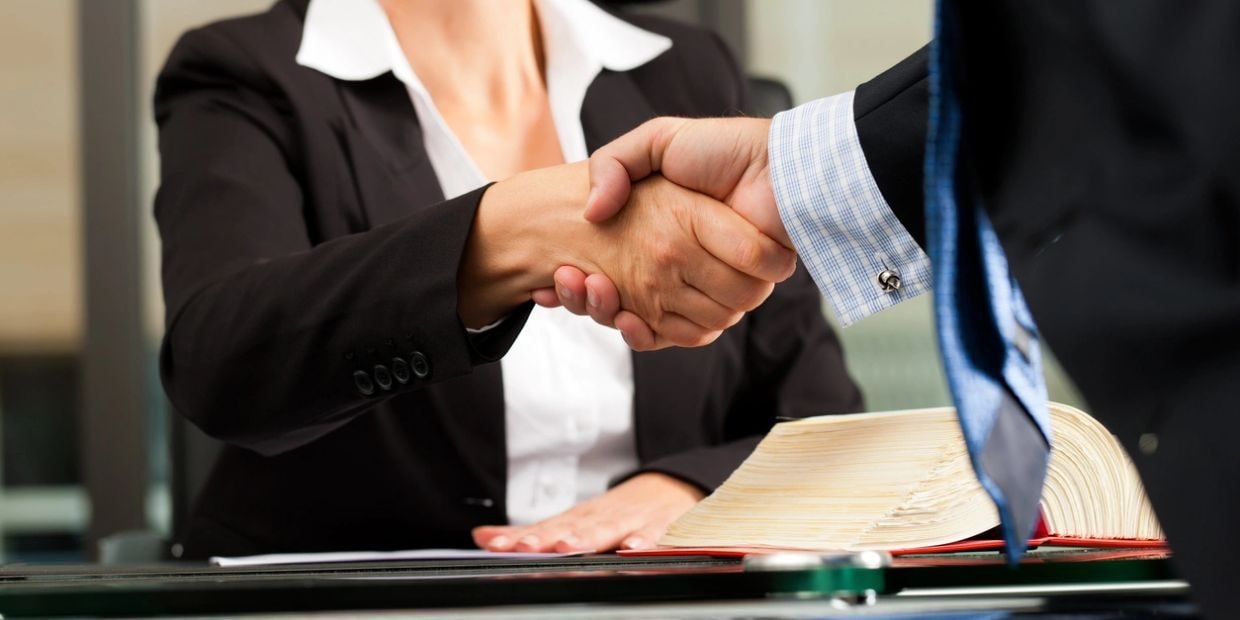 Business professionals shaking hands — symbolizing agreement and partnership